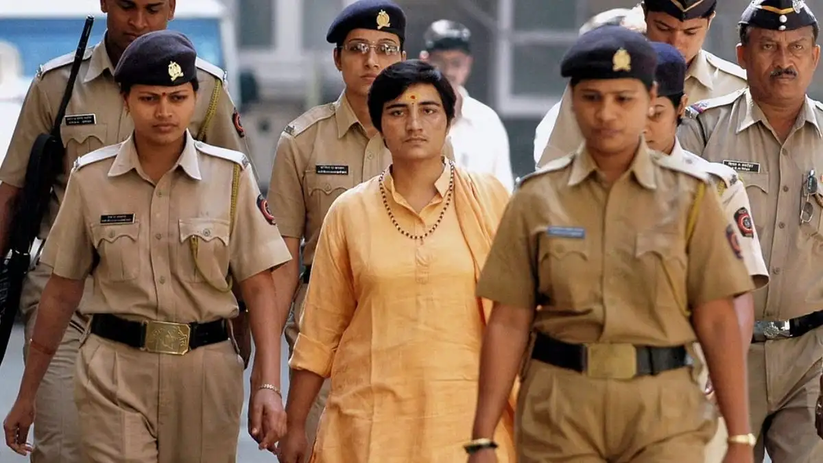 Sadhvi Pragya Singh Thakur escorted by police officers during the Malegaon blast investigation.