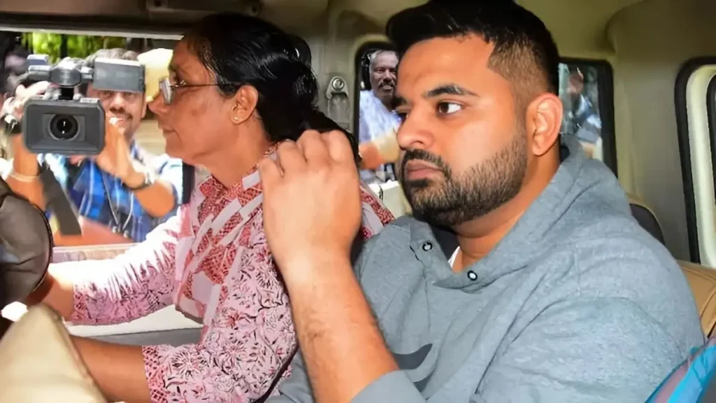 Police escort Prajwal Revanna inside a vehicle after the court verdict in the rape case.