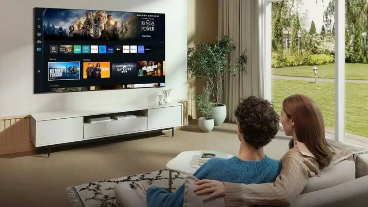 Couple sitting on sofa watching TV together at home during Samsung TV services down.